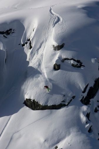 Snowboarder going down a big mountain