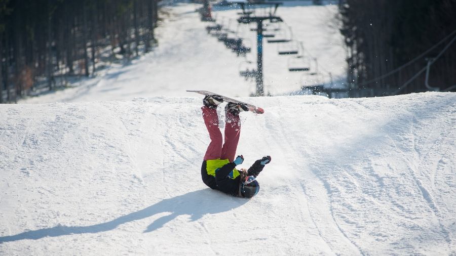 Snowboarder falling over