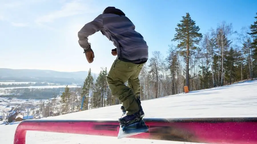 Snowboarder jibbing a rail
