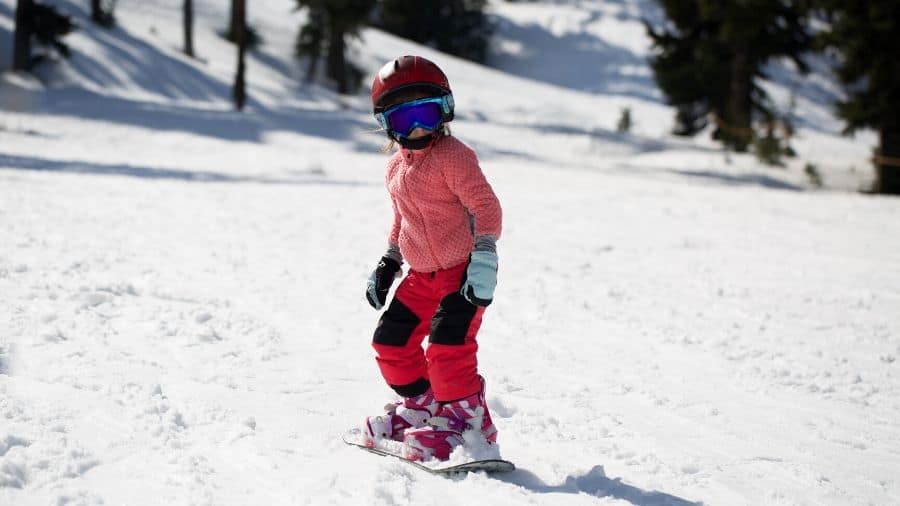 Young girl snowboarding