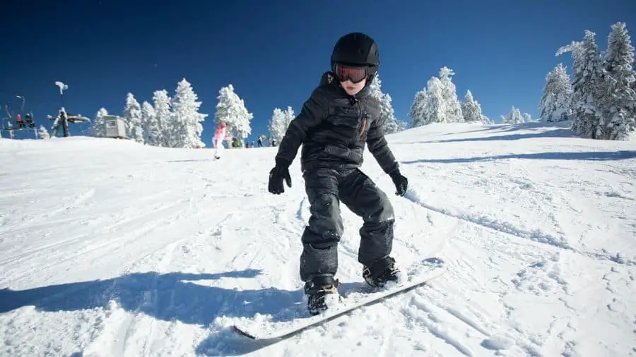 Young boy snowboarding